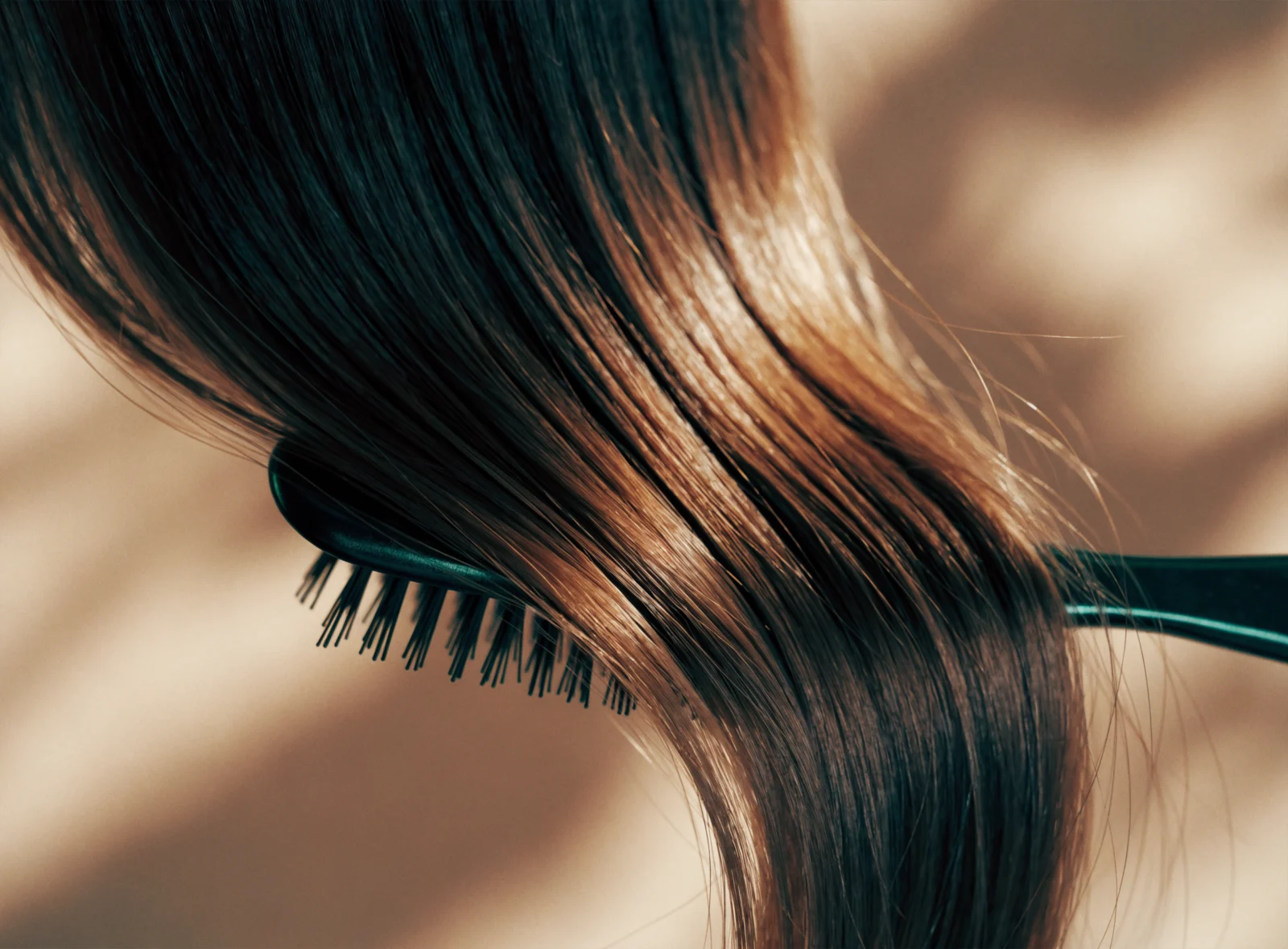 Glossy healthy hair being brushed