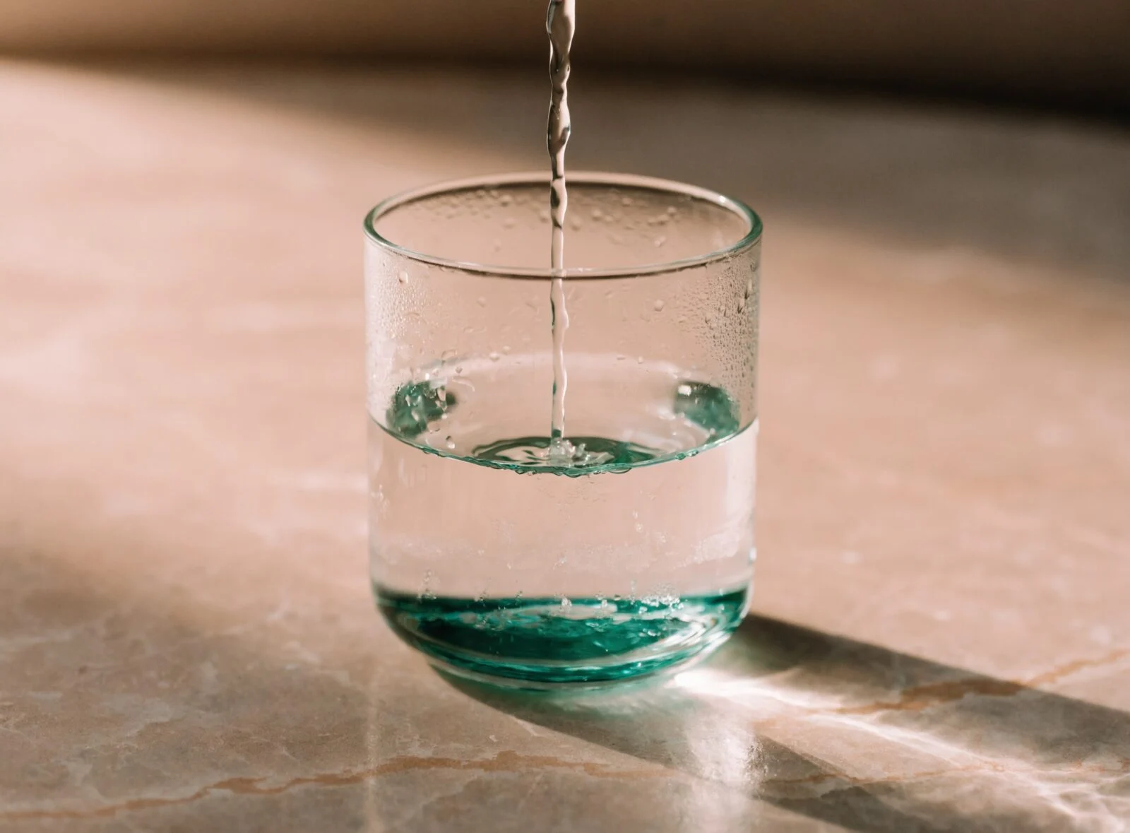 Glass of water being poured